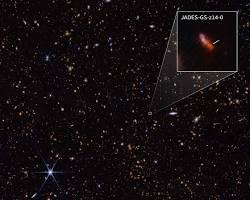 magem infravermelha capturada pelo Telescópio Espacial James Webb destacando a galáxia ancestral JADES-GS-z14-0, observada como era apenas 290 milhões de anos após o Big Bang.